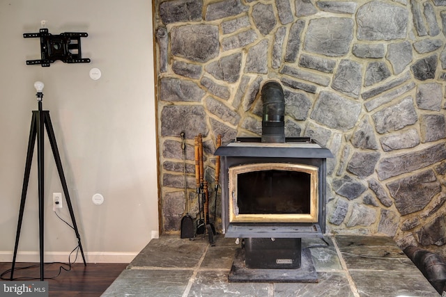 room details with wood-type flooring and a wood stove