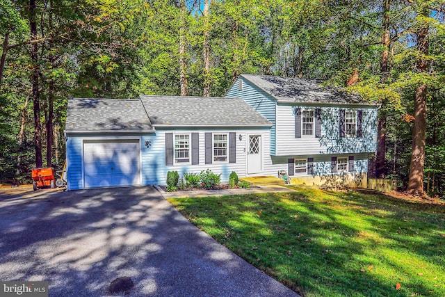 split level home featuring a front lawn and a garage