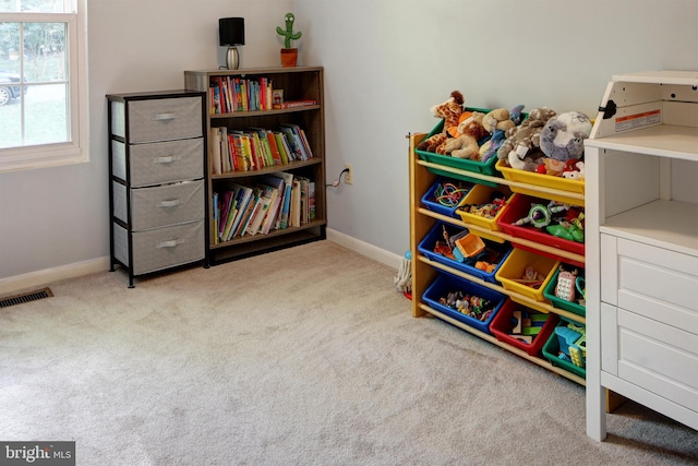 rec room featuring light colored carpet