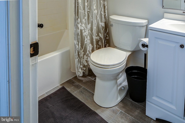 full bathroom with shower / bath combination with curtain, vanity, toilet, and hardwood / wood-style flooring