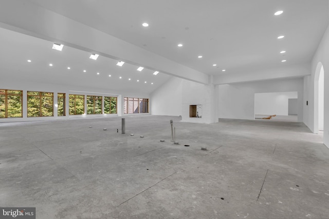 unfurnished living room featuring recessed lighting and vaulted ceiling