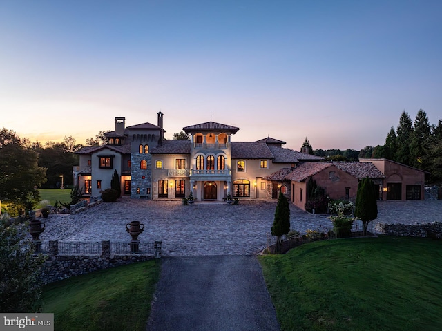 mediterranean / spanish home with a lawn