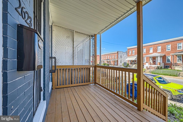 wooden terrace featuring covered porch