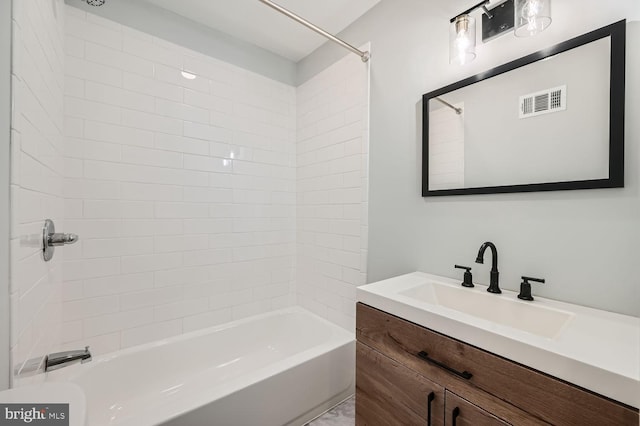 bathroom featuring vanity and tiled shower / bath