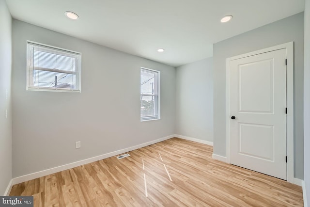 empty room with a healthy amount of sunlight and light wood-type flooring