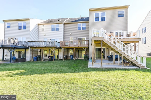 rear view of house featuring a wooden deck, a yard, central air condition unit, and a patio