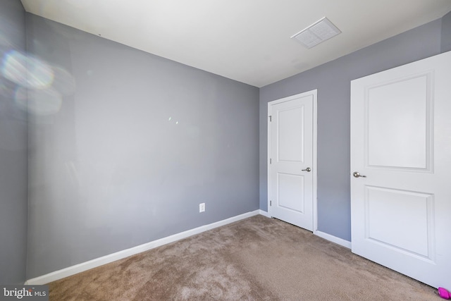 unfurnished bedroom with light colored carpet