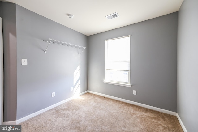 unfurnished room with light colored carpet