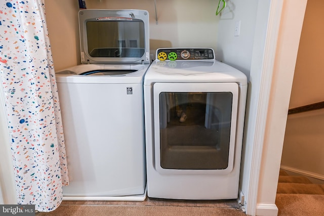 laundry room with light carpet and separate washer and dryer