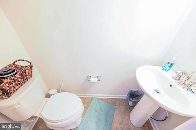 bathroom with toilet and tile patterned flooring