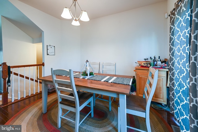 dining room featuring dark wood-type flooring and a notable chandelier