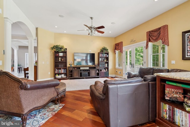 living room with hardwood / wood-style flooring, ornate columns, and ceiling fan