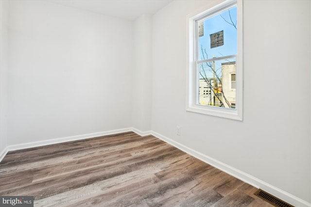 empty room with wood-type flooring