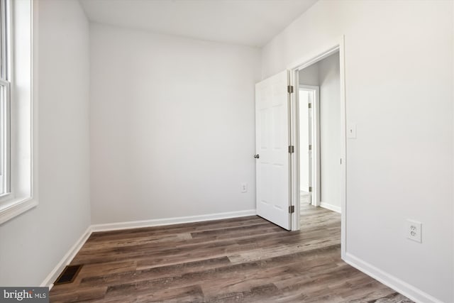 spare room featuring dark hardwood / wood-style flooring