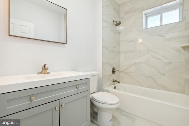 full bathroom featuring vanity, tiled shower / bath combo, and toilet