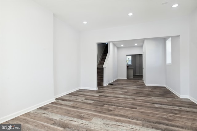 empty room with dark hardwood / wood-style flooring