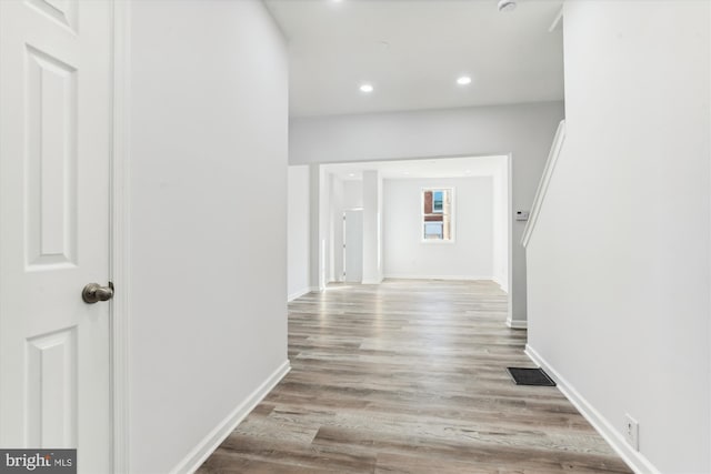 hallway with light hardwood / wood-style floors