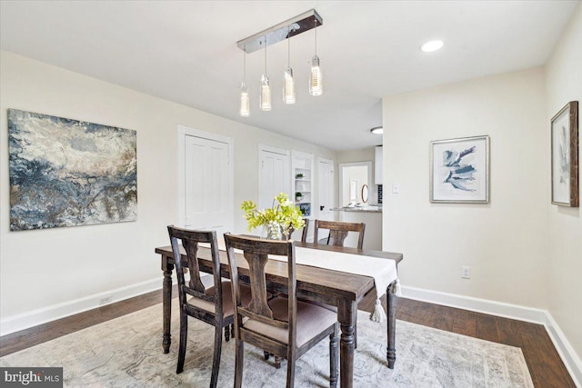 dining room with dark hardwood / wood-style flooring