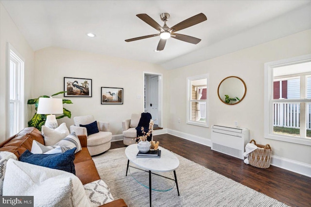 living room with a healthy amount of sunlight, vaulted ceiling, dark hardwood / wood-style floors, and ceiling fan