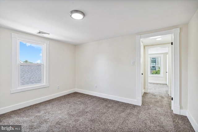 carpeted empty room featuring a healthy amount of sunlight