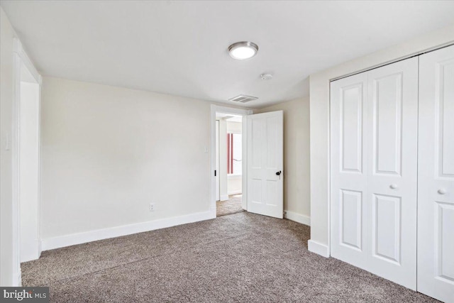 unfurnished bedroom with carpet and a closet