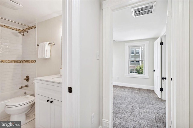 full bathroom with tiled shower / bath combo, vanity, and toilet