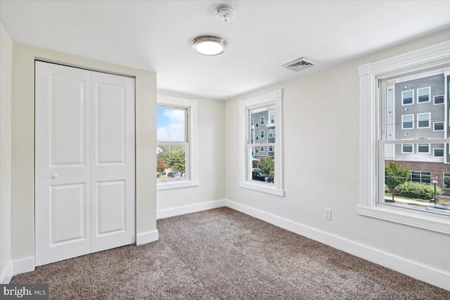 unfurnished bedroom featuring a closet and carpet floors