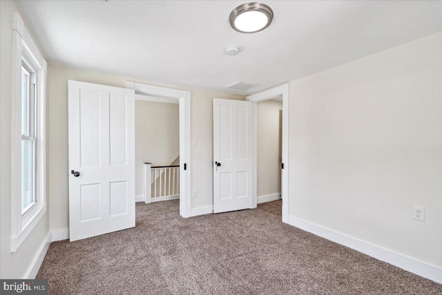 unfurnished bedroom with carpet floors