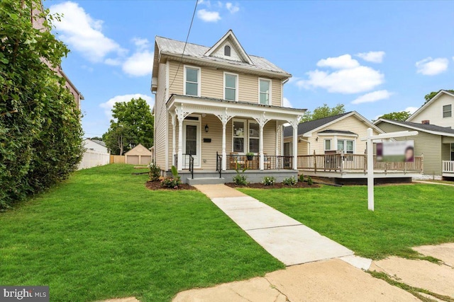 view of front of house with a front yard and a porch