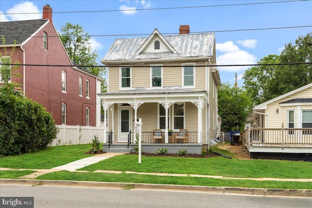 view of front of property with a front yard and covered porch