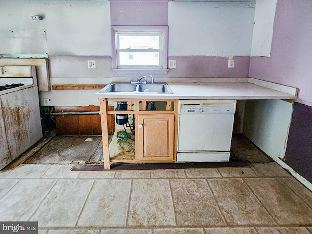 kitchen featuring white dishwasher, light brown cabinetry, and sink