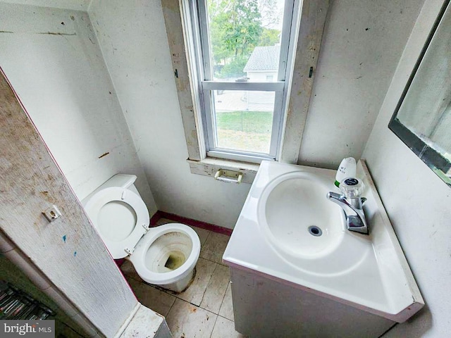 bathroom with tile patterned flooring, toilet, and vanity