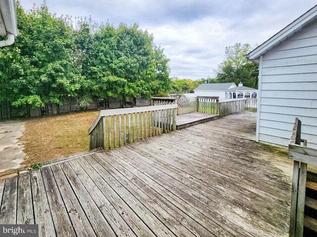 wooden deck featuring a yard