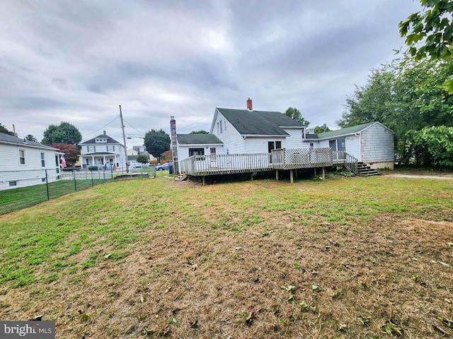 view of yard featuring a wooden deck and a shed