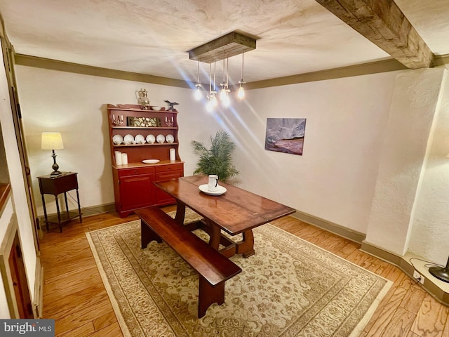 dining room featuring light hardwood / wood-style flooring and crown molding