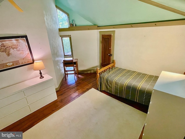 bedroom with hardwood / wood-style floors and high vaulted ceiling