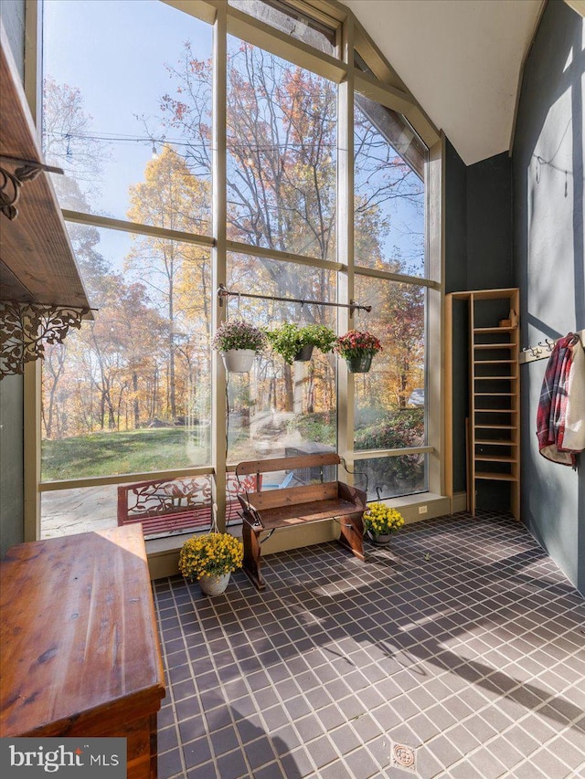 unfurnished sunroom featuring lofted ceiling