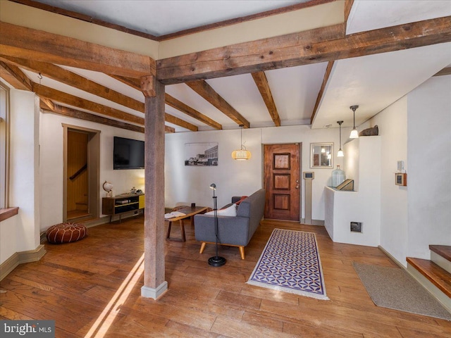 foyer with hardwood / wood-style flooring and beam ceiling