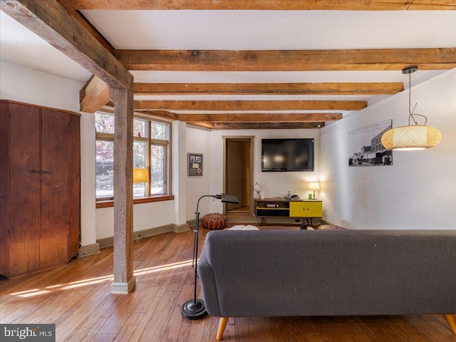 living room featuring hardwood / wood-style floors and beam ceiling