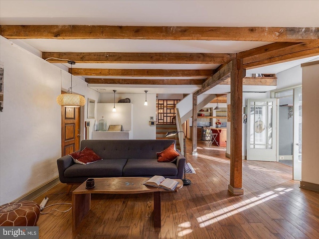 living room with beamed ceiling and wood-type flooring