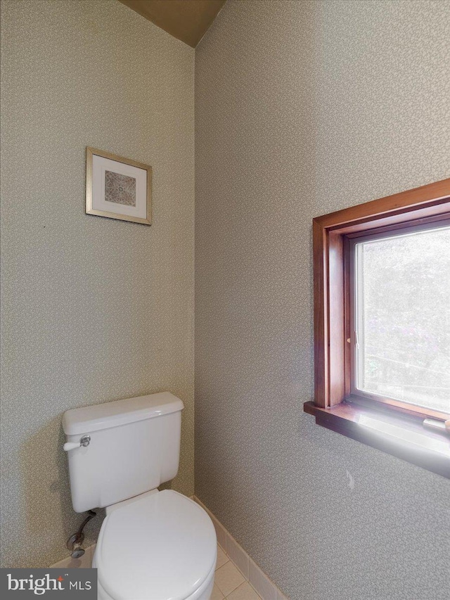 bathroom with toilet and tile patterned floors