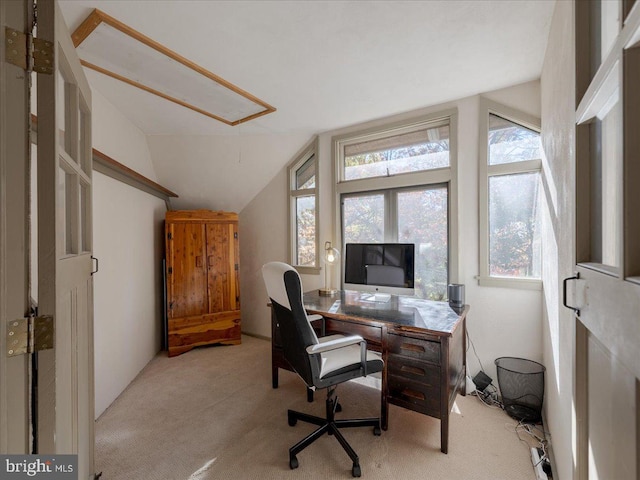 carpeted office space with vaulted ceiling