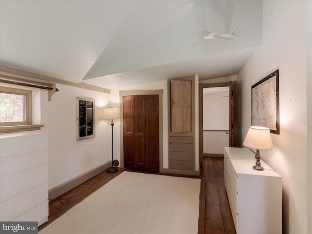 unfurnished bedroom featuring dark hardwood / wood-style flooring and lofted ceiling