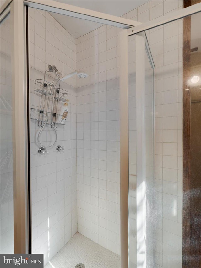 bathroom with tiled shower