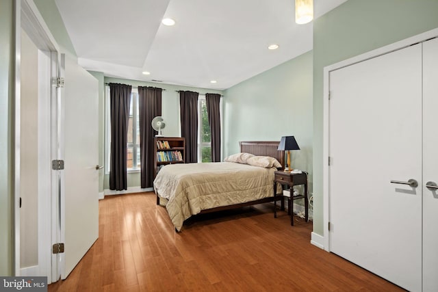 bedroom with a closet and hardwood / wood-style floors