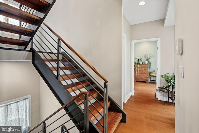 stairs with hardwood / wood-style floors