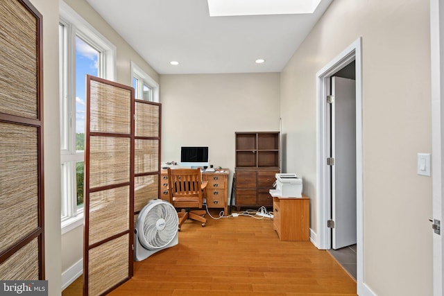 home office featuring plenty of natural light and hardwood / wood-style flooring