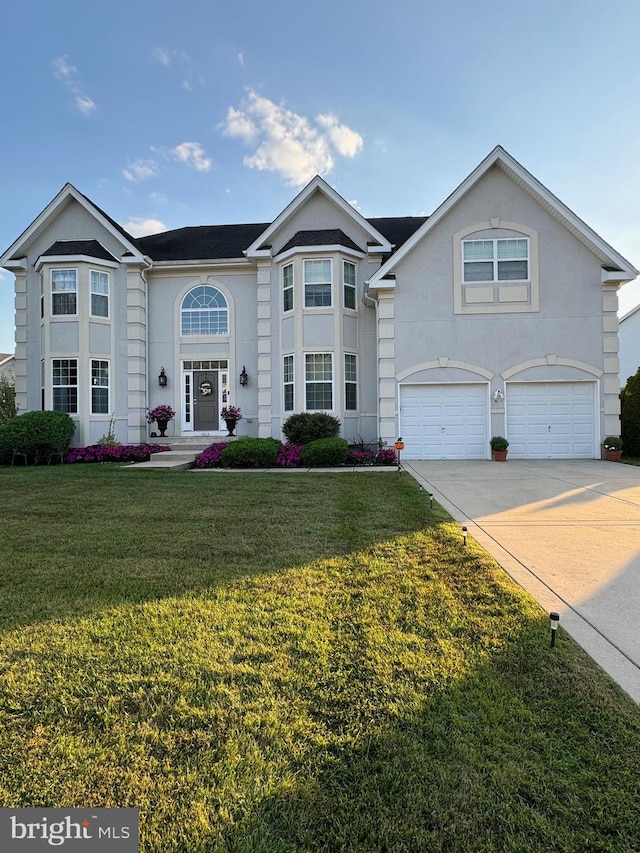 front of property featuring a garage and a front lawn