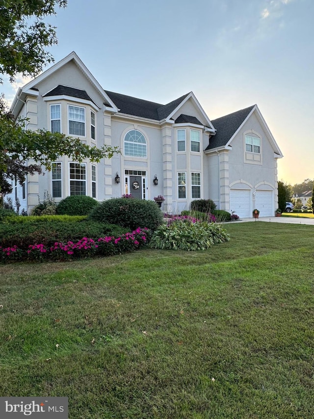 view of front facade featuring a garage and a lawn