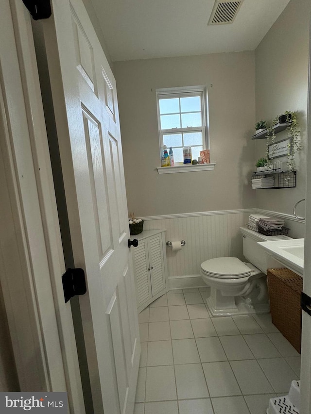 bathroom with tile patterned flooring, vanity, and toilet